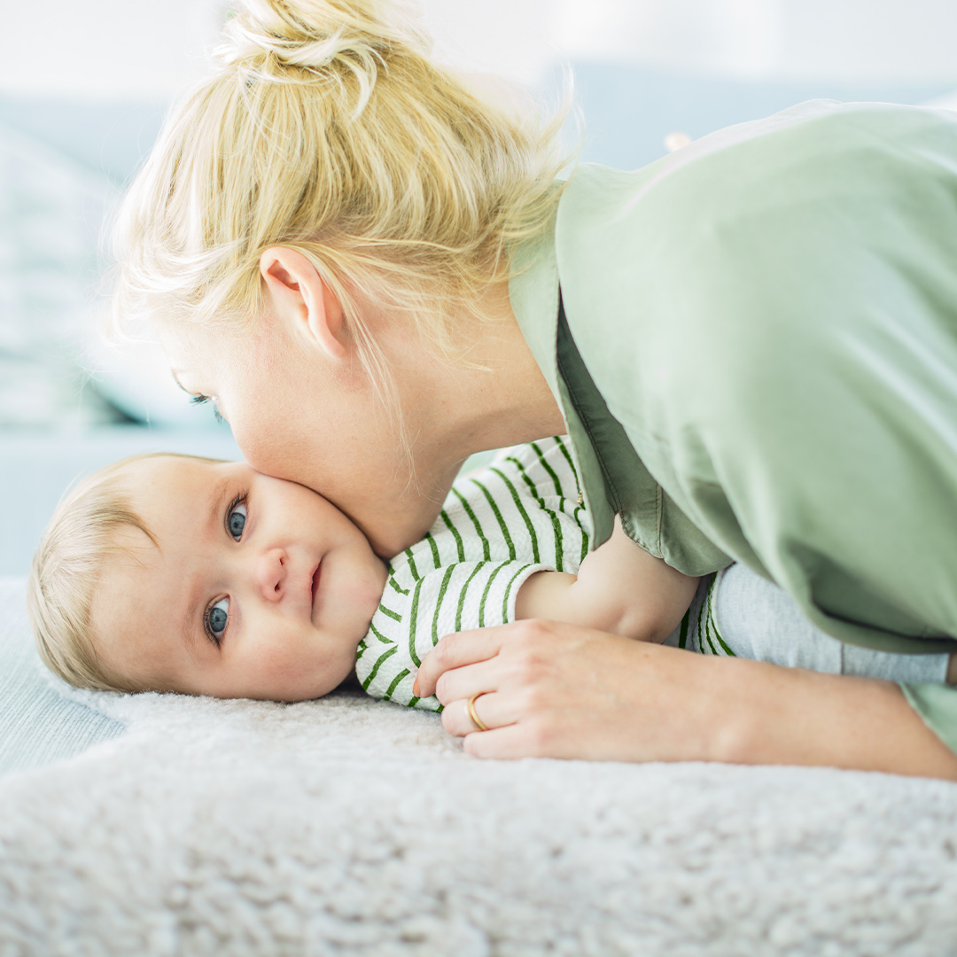 Mother kissing her baby