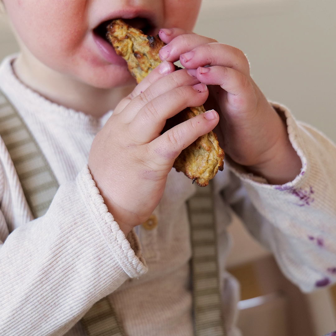Baby eating porridge stick