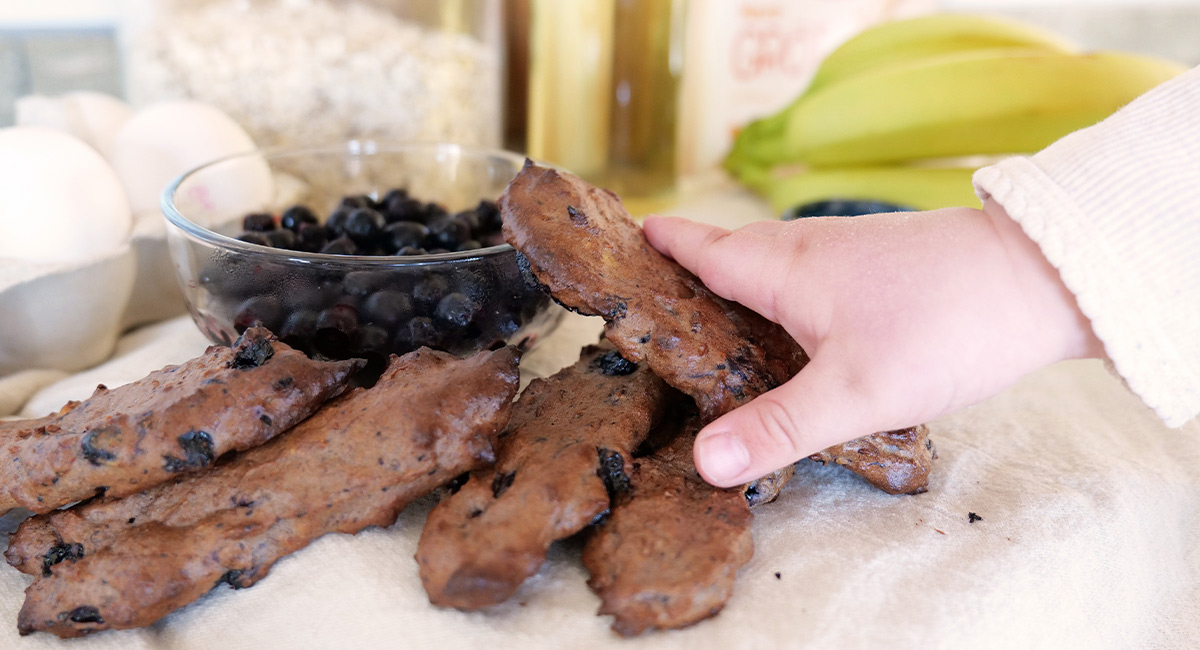 Baby hand with porridge sticks